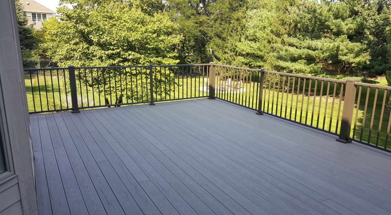 Professional composite deck installation with modern railings